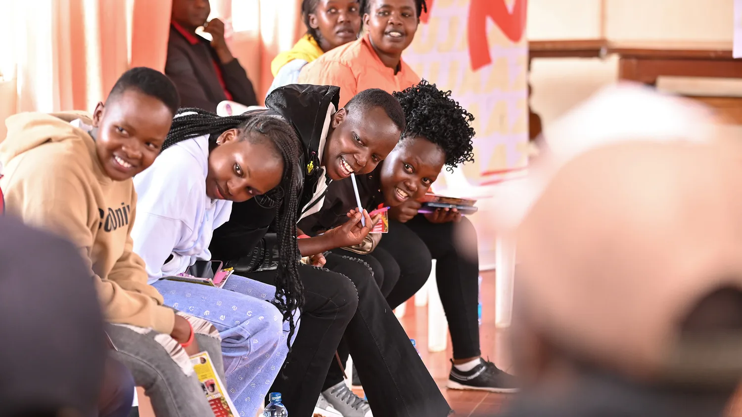 A group of young Kenyans laughing together at a Surround Sound Kenya session