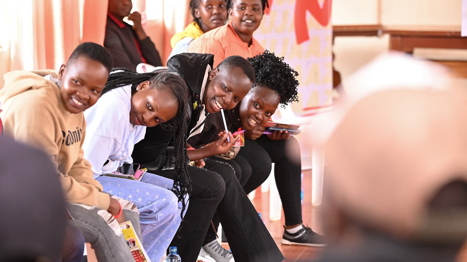 A group of young Kenyans laughing together at a Surround Sound Kenya session