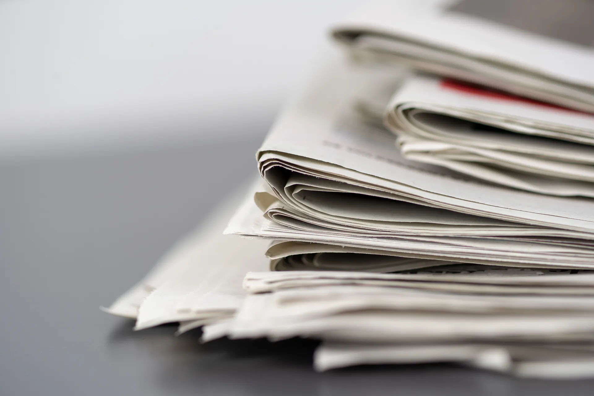 A stack of folded newspapers